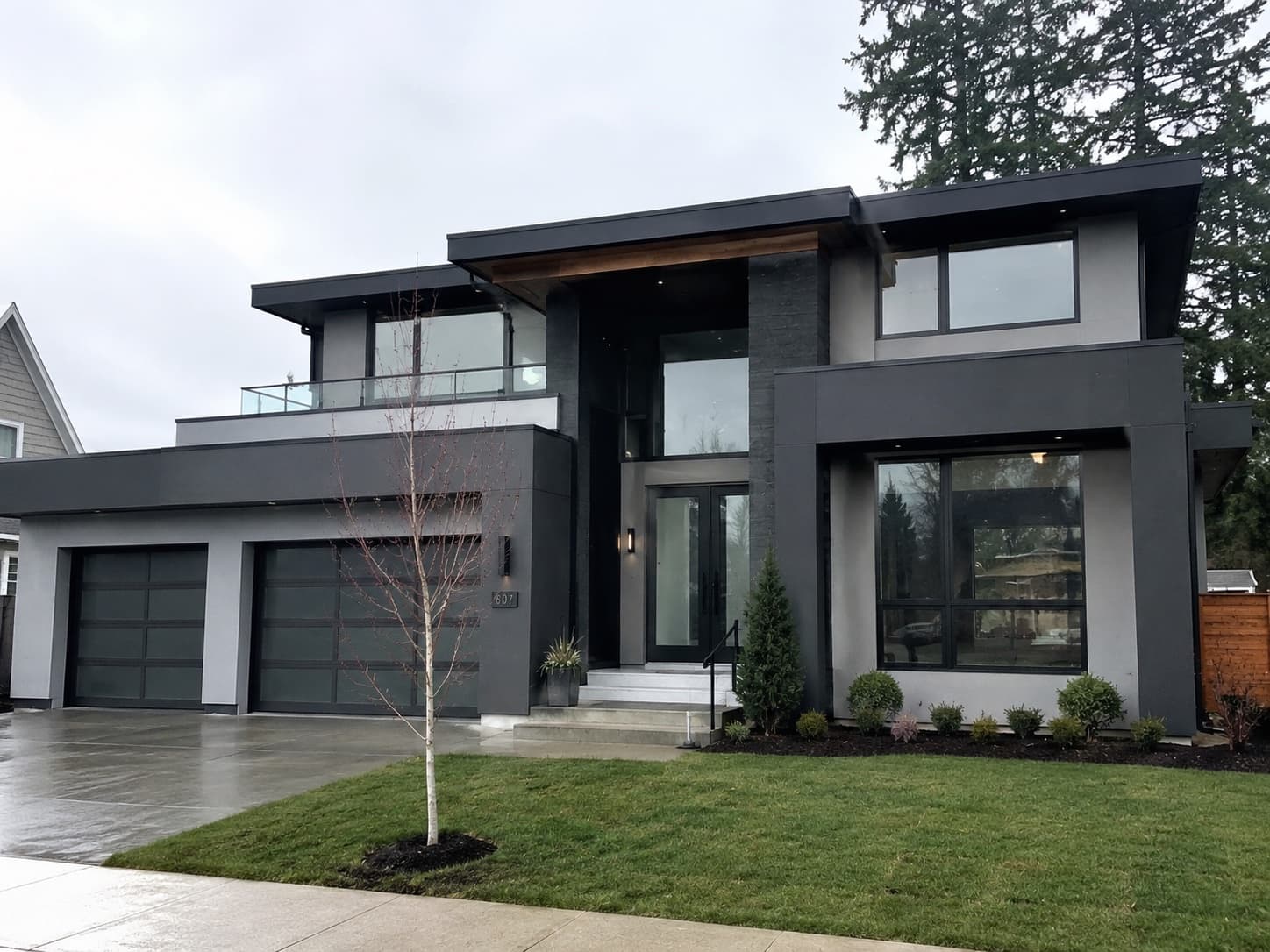 Modern dark-gray exterior repaint with stone accents in Forest Acres