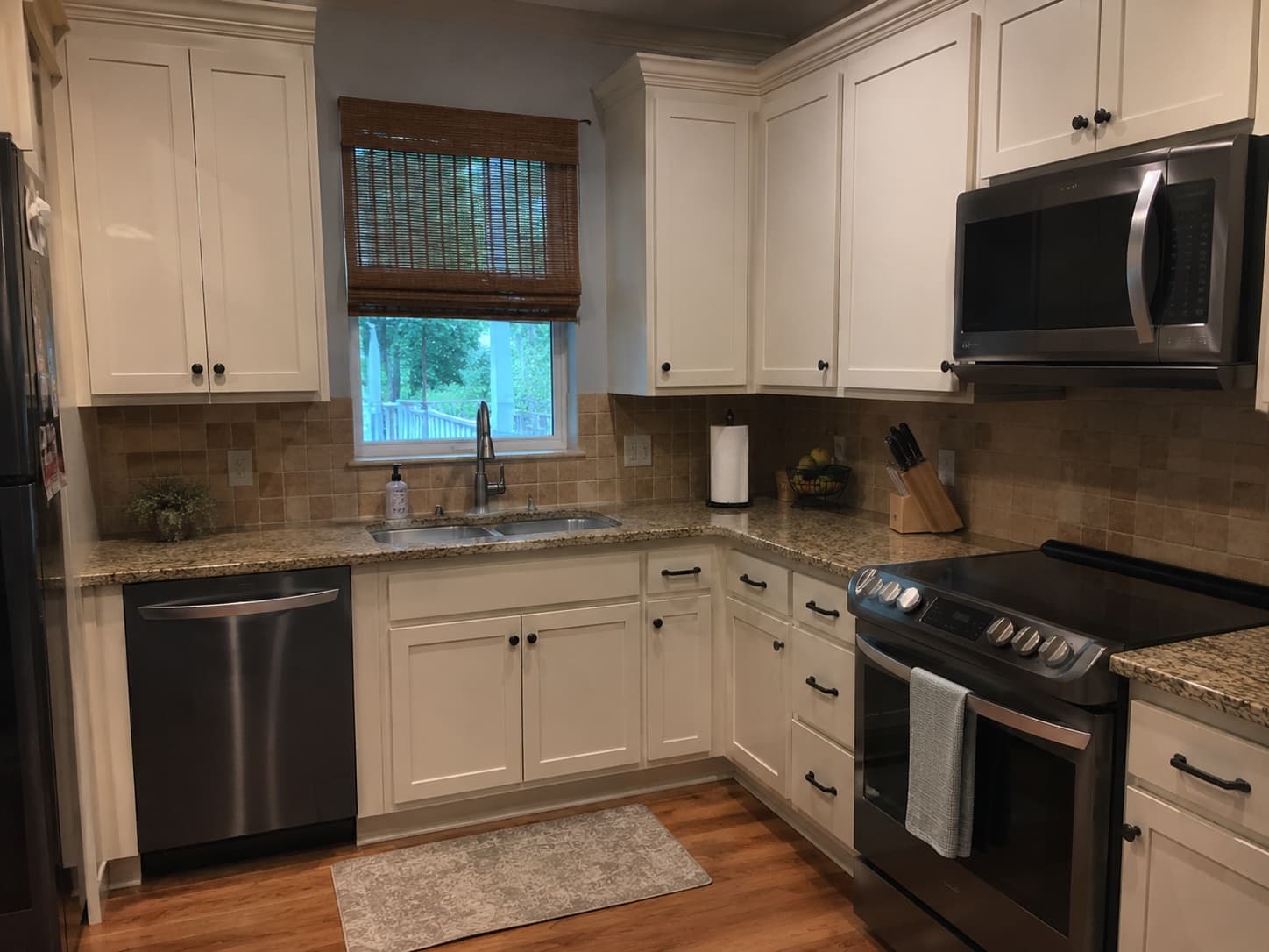 Soft-white shaker cabinet refresh with granite counters in Spartanburg